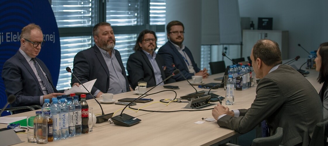 A group of people on both sides of the conference table