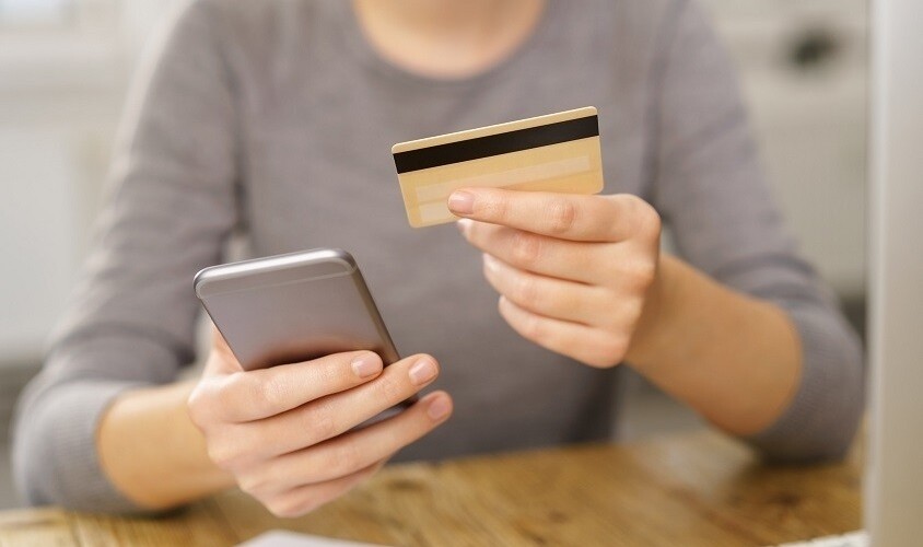 Woman with mobile phone and credit card
