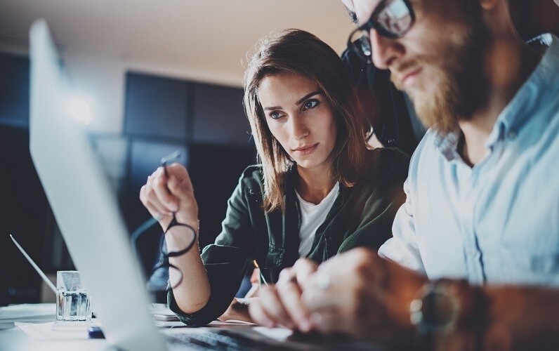 Woman and man working on laptop