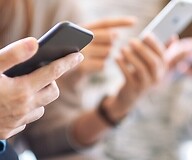 Dłonie trzymające smartfony